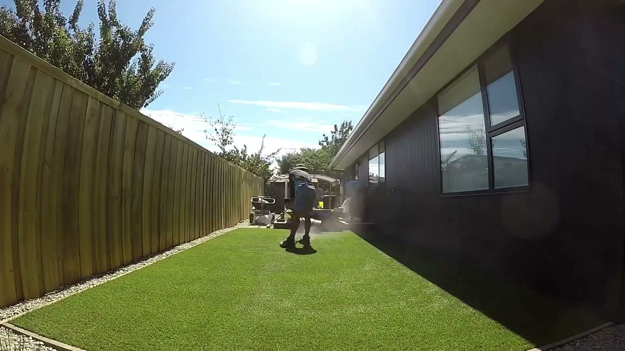 Freshly laid artificial turf in a backyard